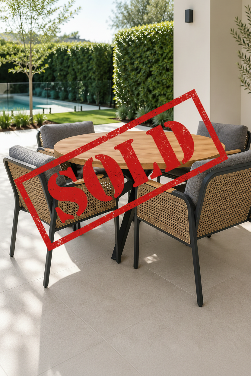 Round wooden outdoor table with four matching chairs on a patio.